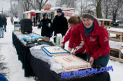 Program director Meridith Legge cutting cake.